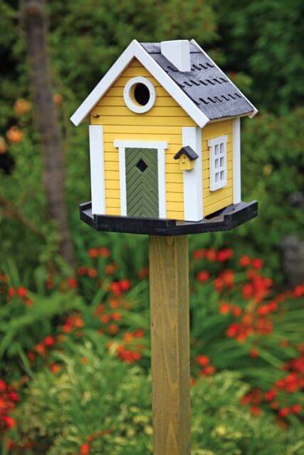 Cottage yellow birdhouse 10 Birdhouses to Decorate Your Outdoor Space 