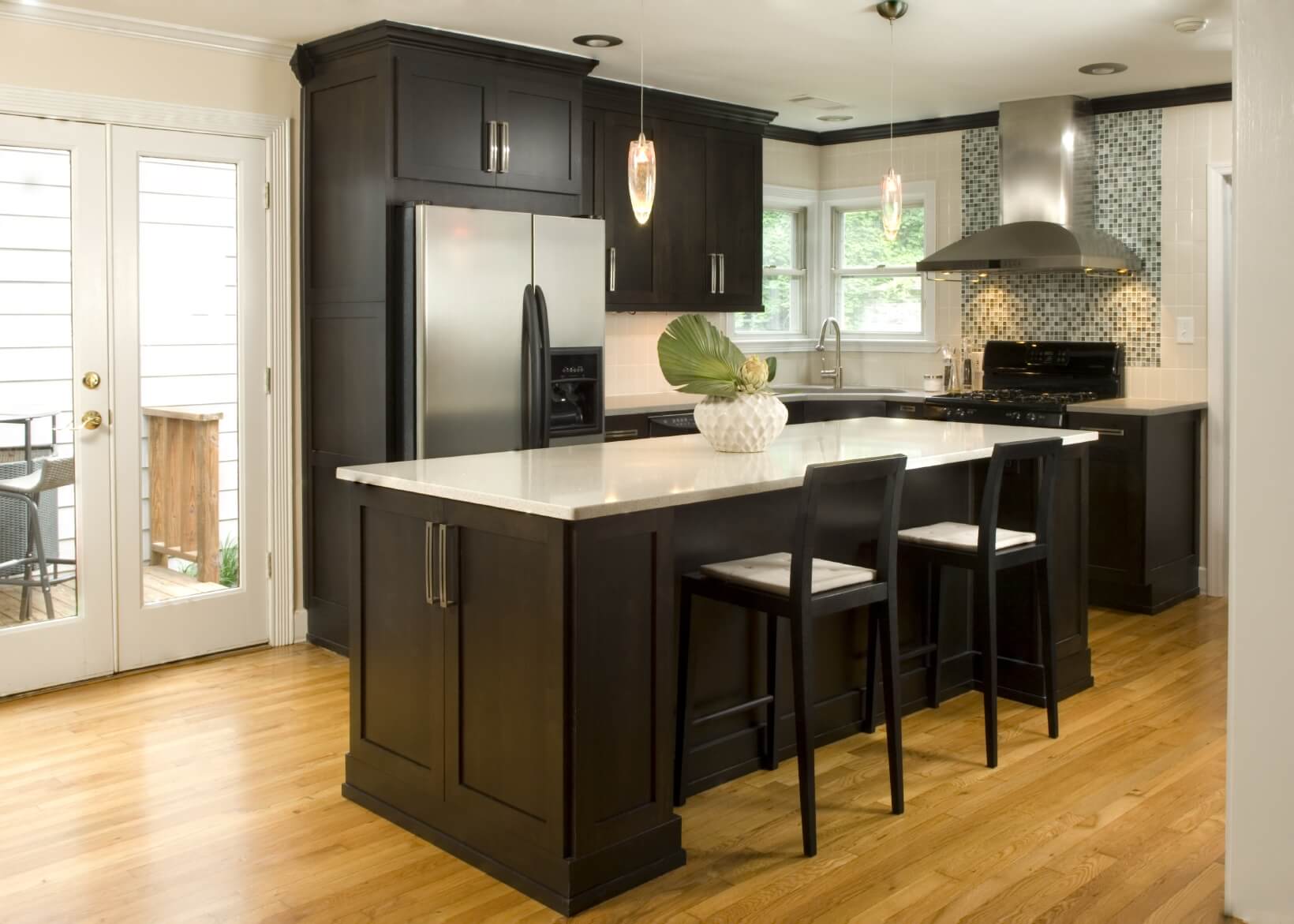 black kitchen cabinet with light brown counter top