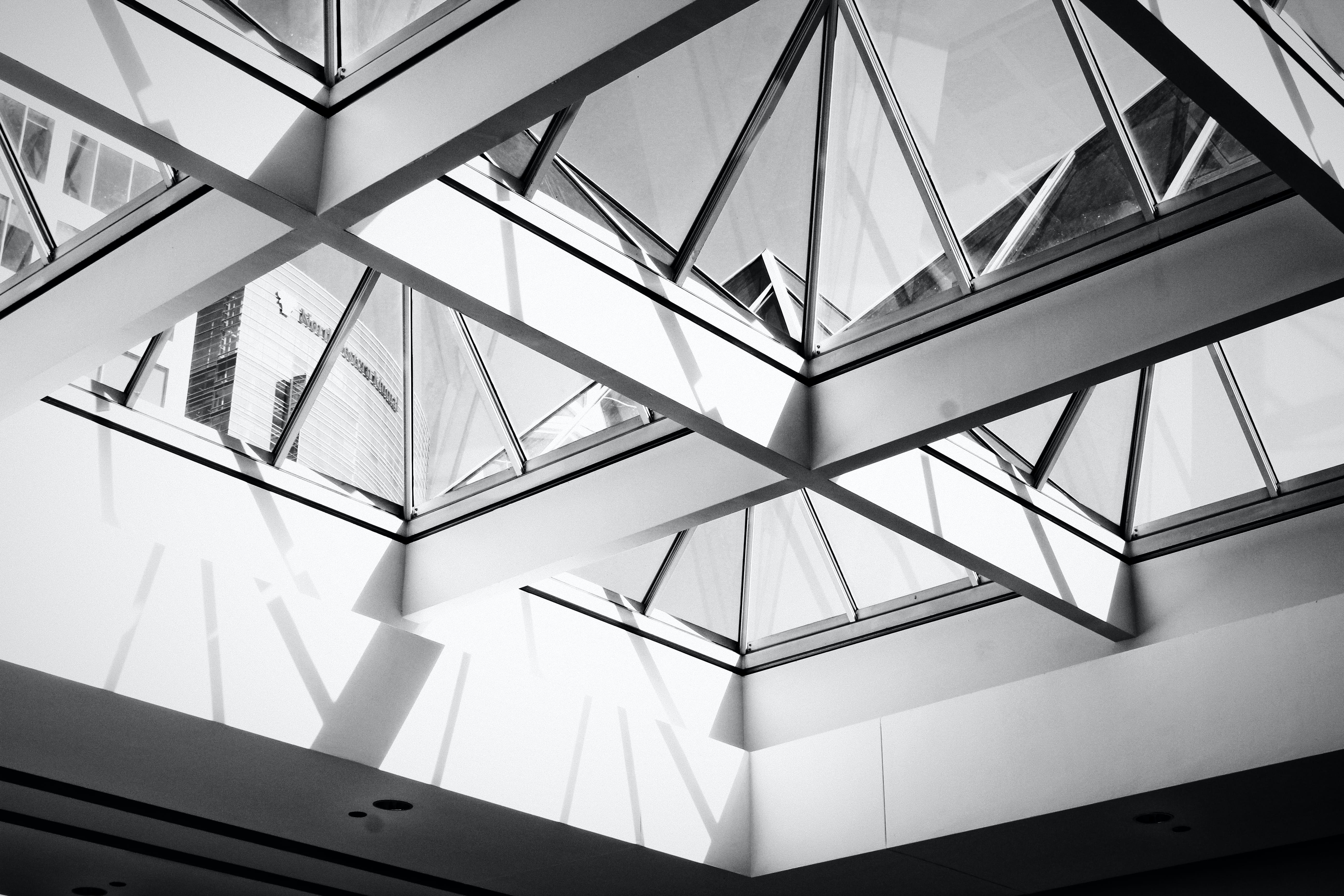 low angle photography of white framed glass roof