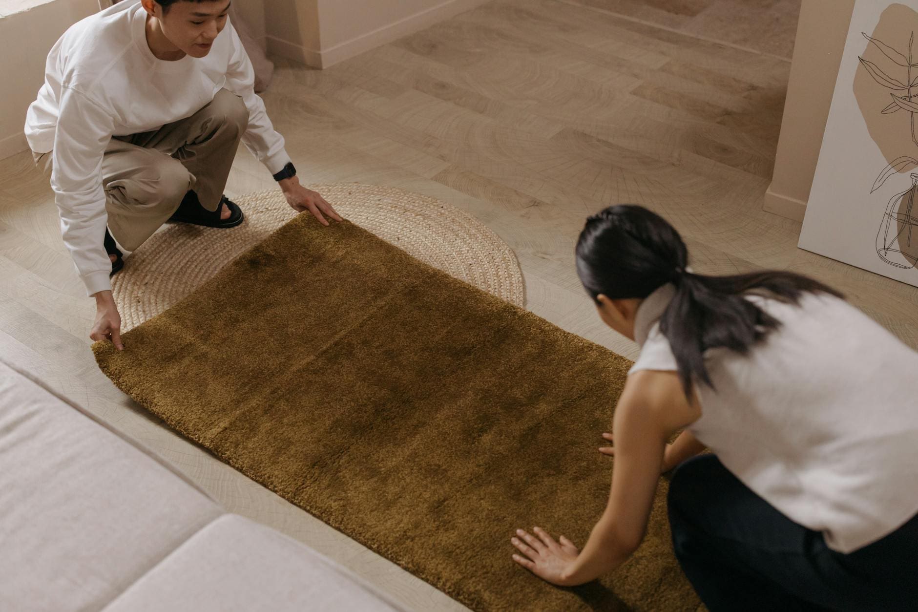 https://www.pexels.com/photo/a-couple-laying-down-a-brown-rug-on-the-floor-7417511/
