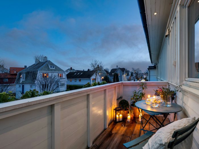 Charming balcony setting with decorative lanterns providing a soft glow.