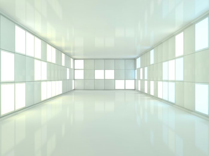 Bright, futuristic room with illuminated panels on the walls, featuring a clean and minimalist design with reflective surfaces.