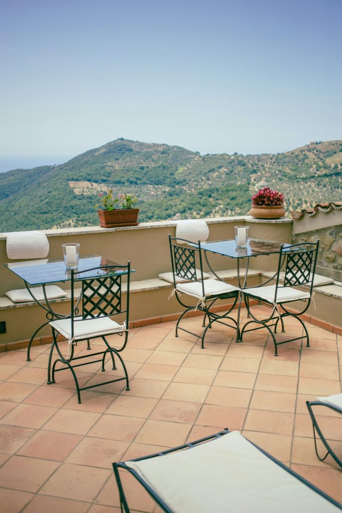 Small balcony furnished with a bistro set for outdoor dining.