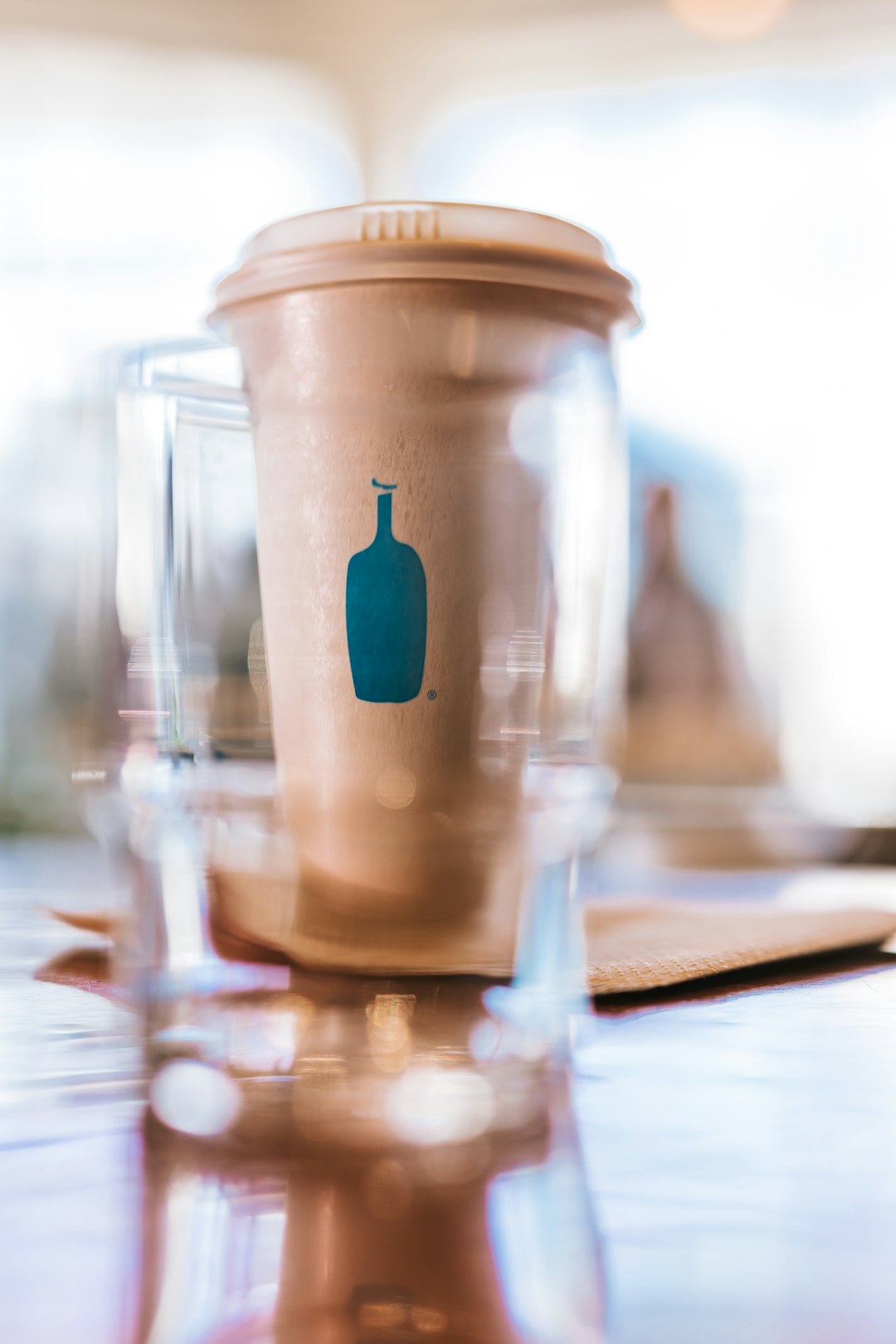 clear glass jar with blue lid on brown wooden table