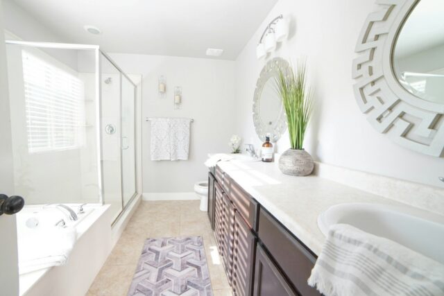 a bathroom with a sink, mirror, and bathtub