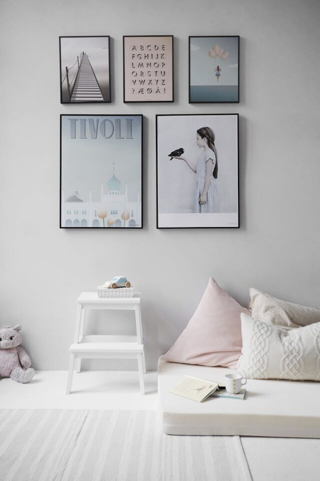 five posters mounted on wall