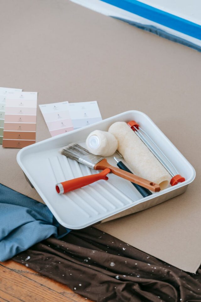 paint roller and brush on plastic tray