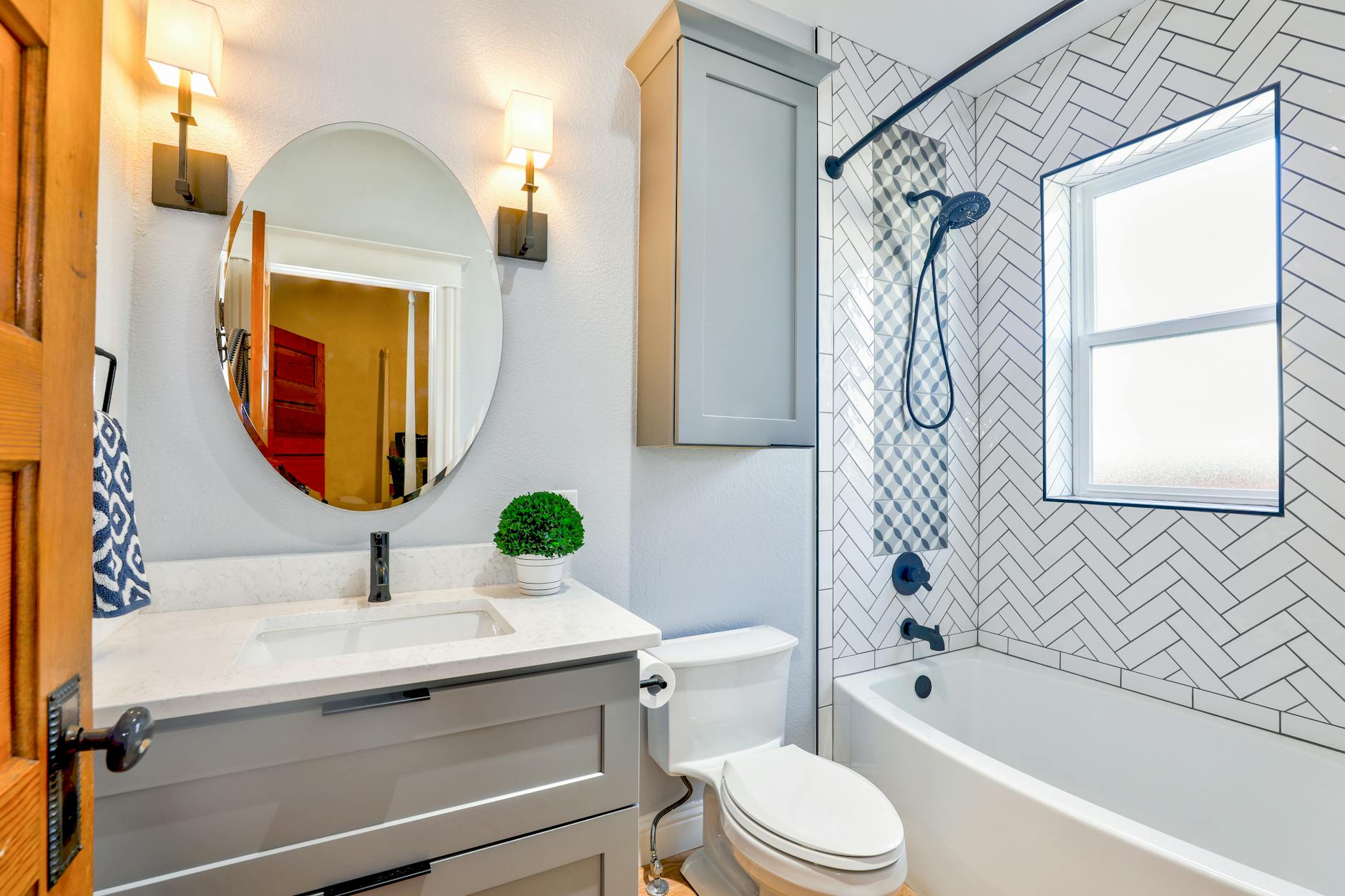 oval mirror near toilet bowl, Smart faucet example from plumber-approved bathroom upgrades