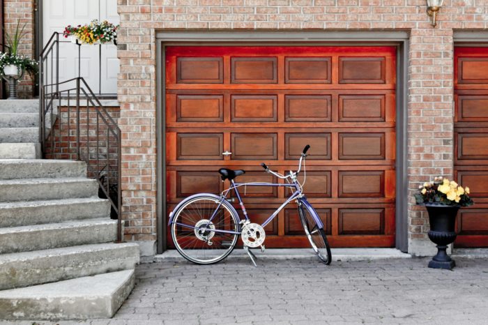 Contemporary garage door with glass panels and aluminum frame, perfect for modern home design in St. Paul.