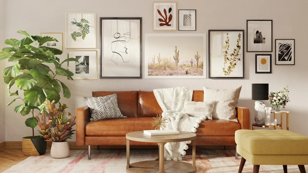 Boho living room with brown leather sofa, gallery wall art, indoor plants, and wood coffee table on patterned rug