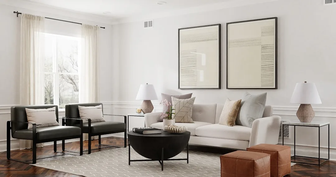 Modern living room with white sofa, black coffee table, and two abstract art pieces as focal statement wall decor