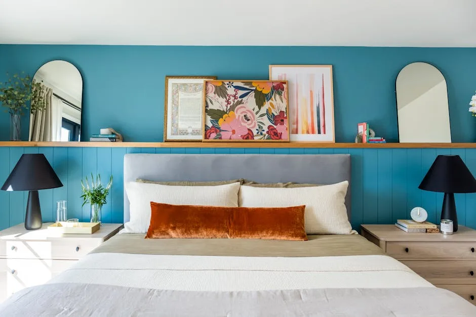 Floating wood shelf above bed as nightstand alternative in small bedroom with teal accent wall and zero floor footprint