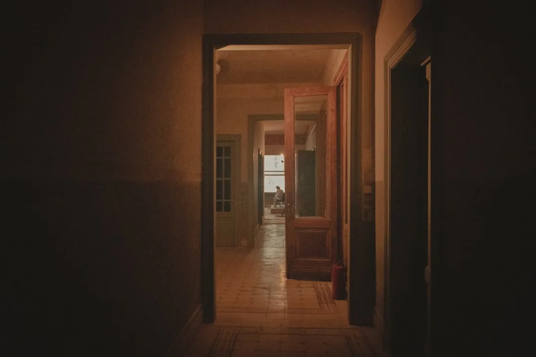 Dark hallway with multiple doorways showing 36-inch primary circulation path through connected rooms