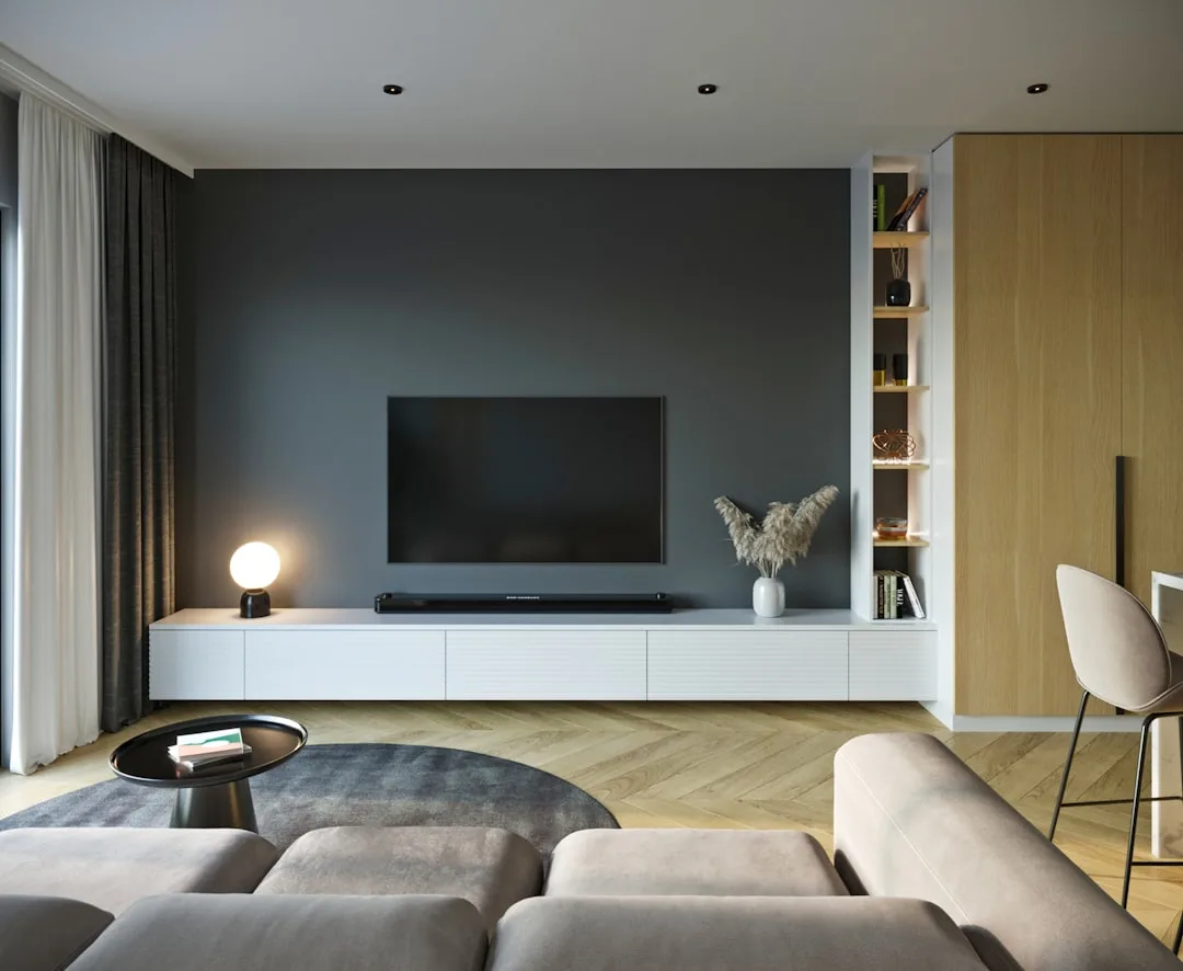 Modern living room TV console wall with open floor space on sides, white floating cabinet, dark accent wall and wood she