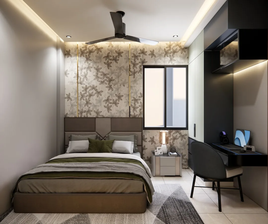 Modern bedroom with recessed ceiling cove lighting, ceiling fan, bedside lamp, and LED accent lights above wardrobe