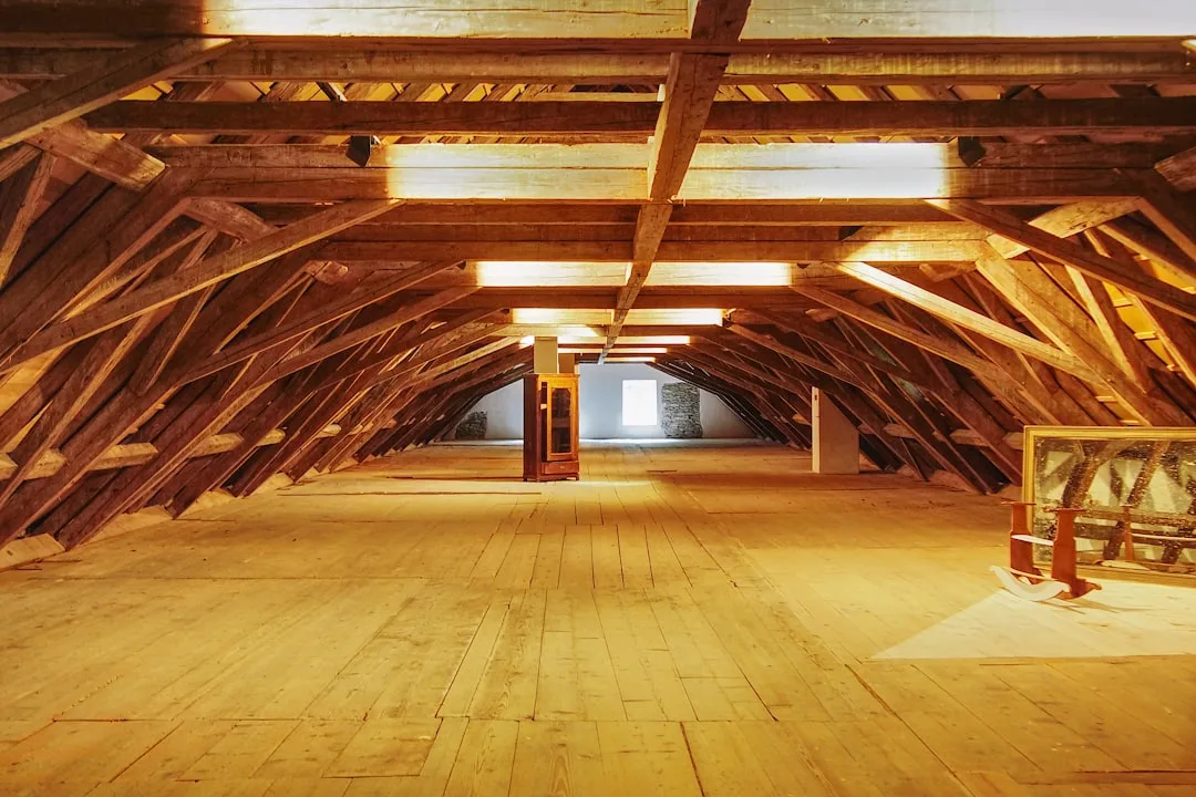 Exposed wooden roof trusses and plank flooring in