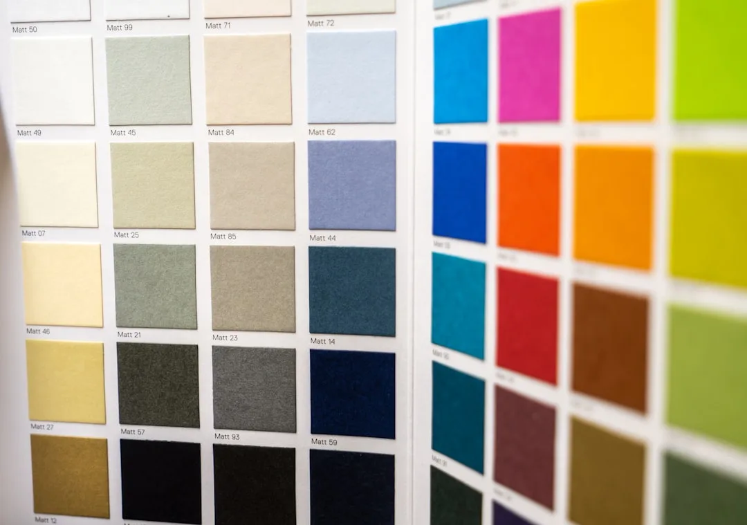 Color swatch chart showing matte paint samples from neutral whites to deep darks and vibrant hues for color temperature 