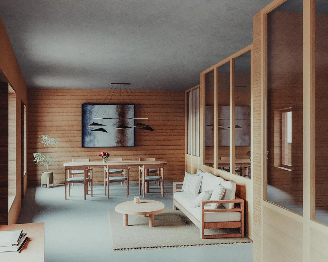 Japandi living and dining room with warm wood walls, minimalist furniture, neutral tones, and pendant lighting