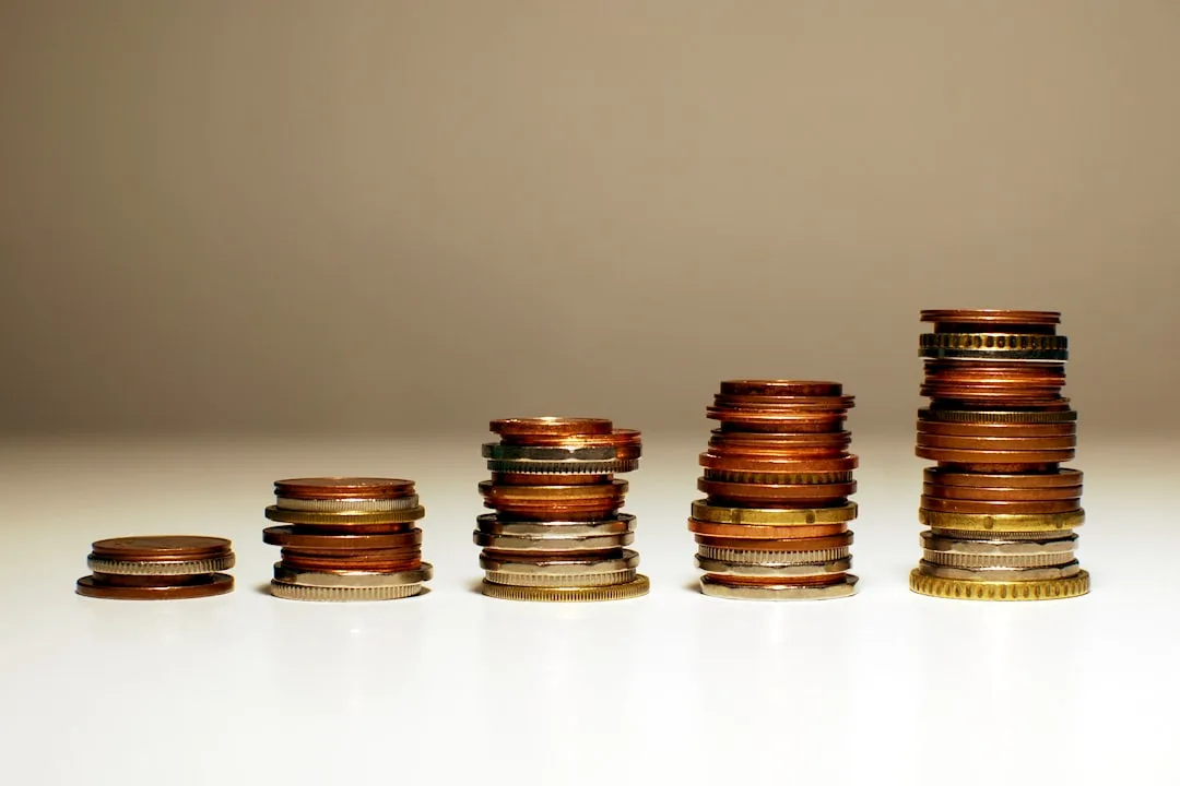 Five stacks of coins in ascending height showing cost comparison and increasing price tiers