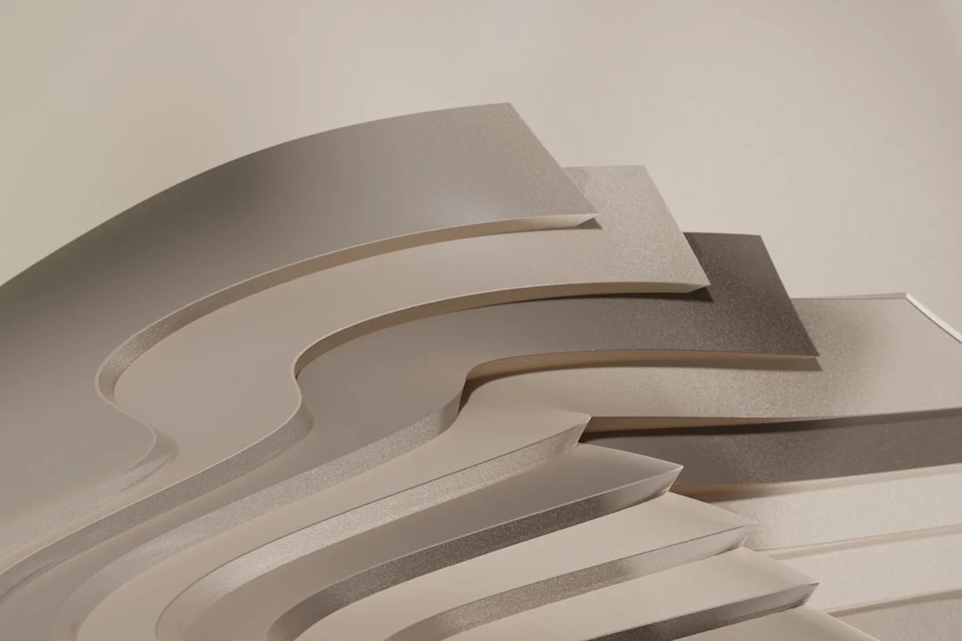 Layered curved organic sculptural forms in neutral tones showing fluid architectural shapes