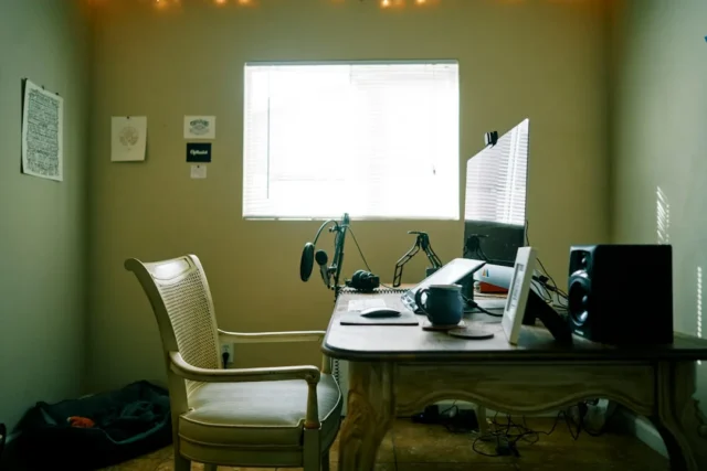 Home recording studio desk setup with condenser mi
