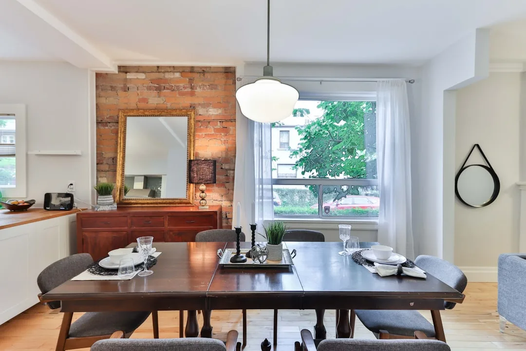 Eclectic dining room with dark wood table, exposed