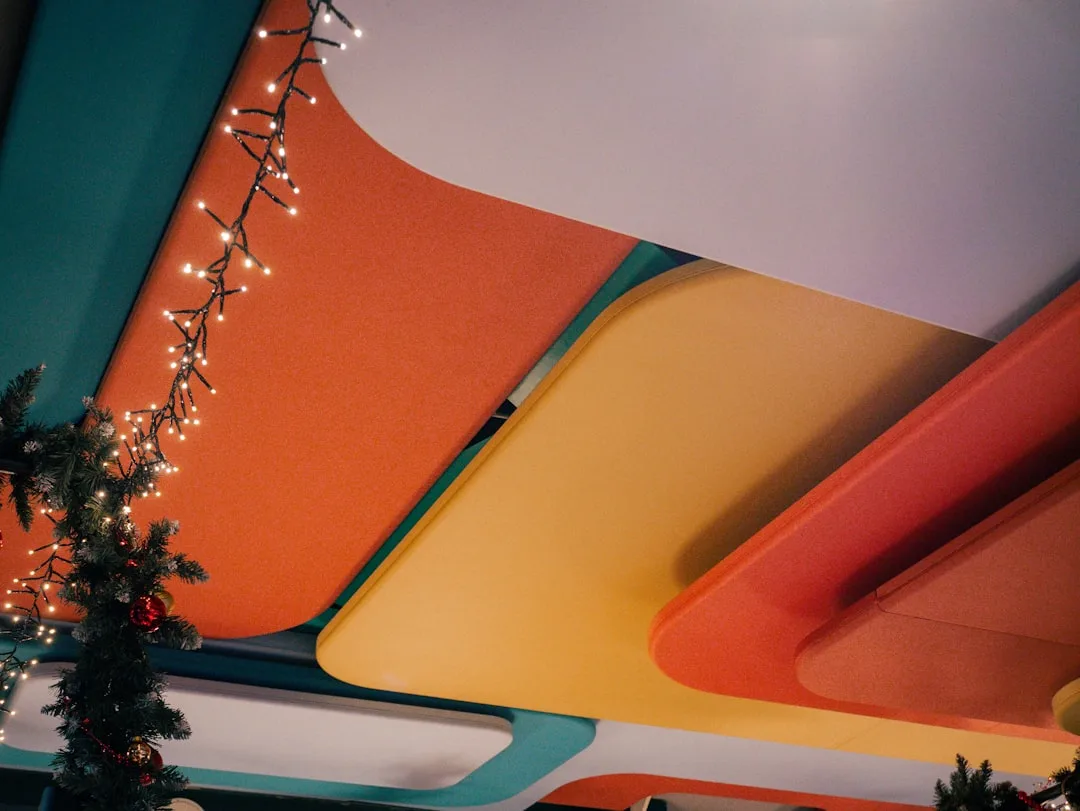 Colorful retro ceiling with Christmas fairy lights and decorated tree for holiday ceiling decoration ideas
