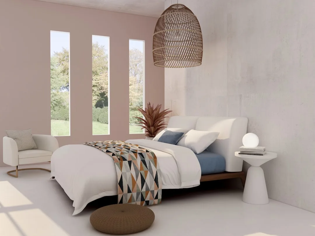 Cozy bedroom with warm ambient lighting, wicker pendant lamp, white bedding, and natural light from tall windows