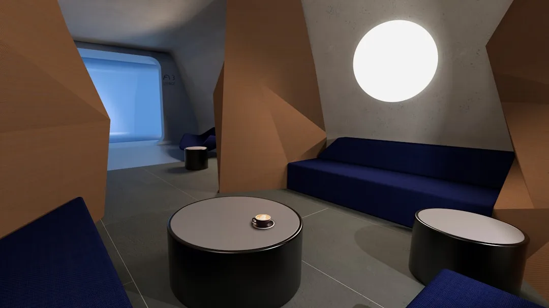 Futuristic lounge with angled walls, blue sofa, and round coffee tables arranged in conversation-friendly configuration