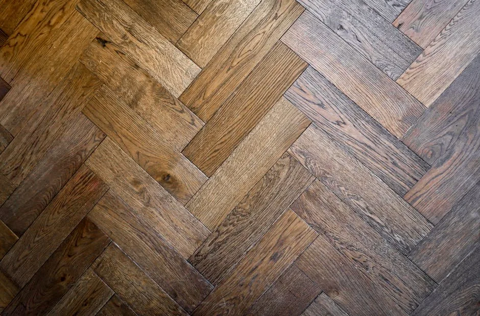 Dark oak herringbone parquet flooring with rich wood grain texture and classic zigzag pattern
