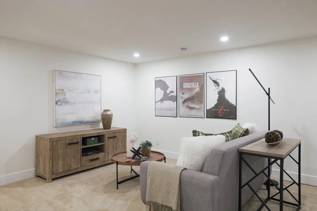 Floor lamp on console table behind gray sofa in living room showing lamp height relationship to seating