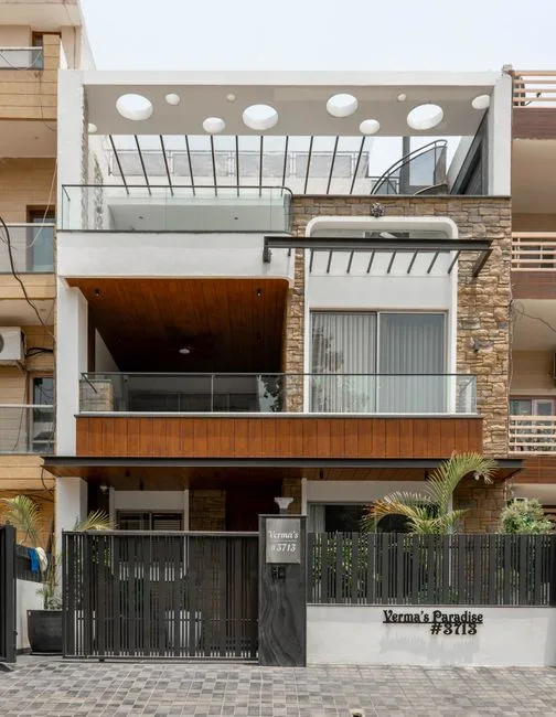 Verma's Paradise modern contemporary home exterior with wood cladding, glass railings, and stone facade in India