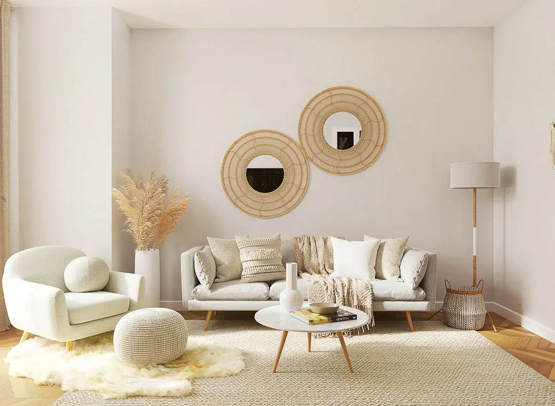 Budget-friendly boho living room with neutral tones, rattan mirrors, linen sofa, and natural texture accents