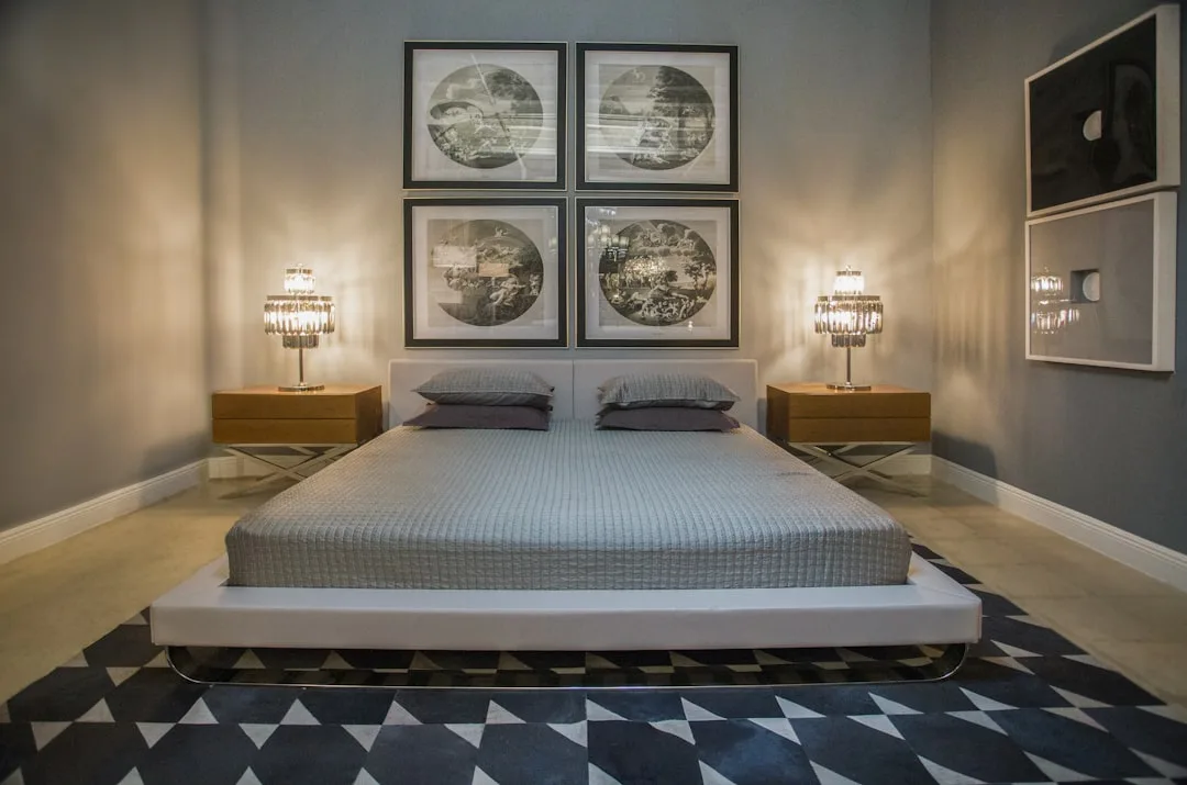 King size platform bed with geometric area rug in modern bedroom showing rug sizing in relation to large mattress