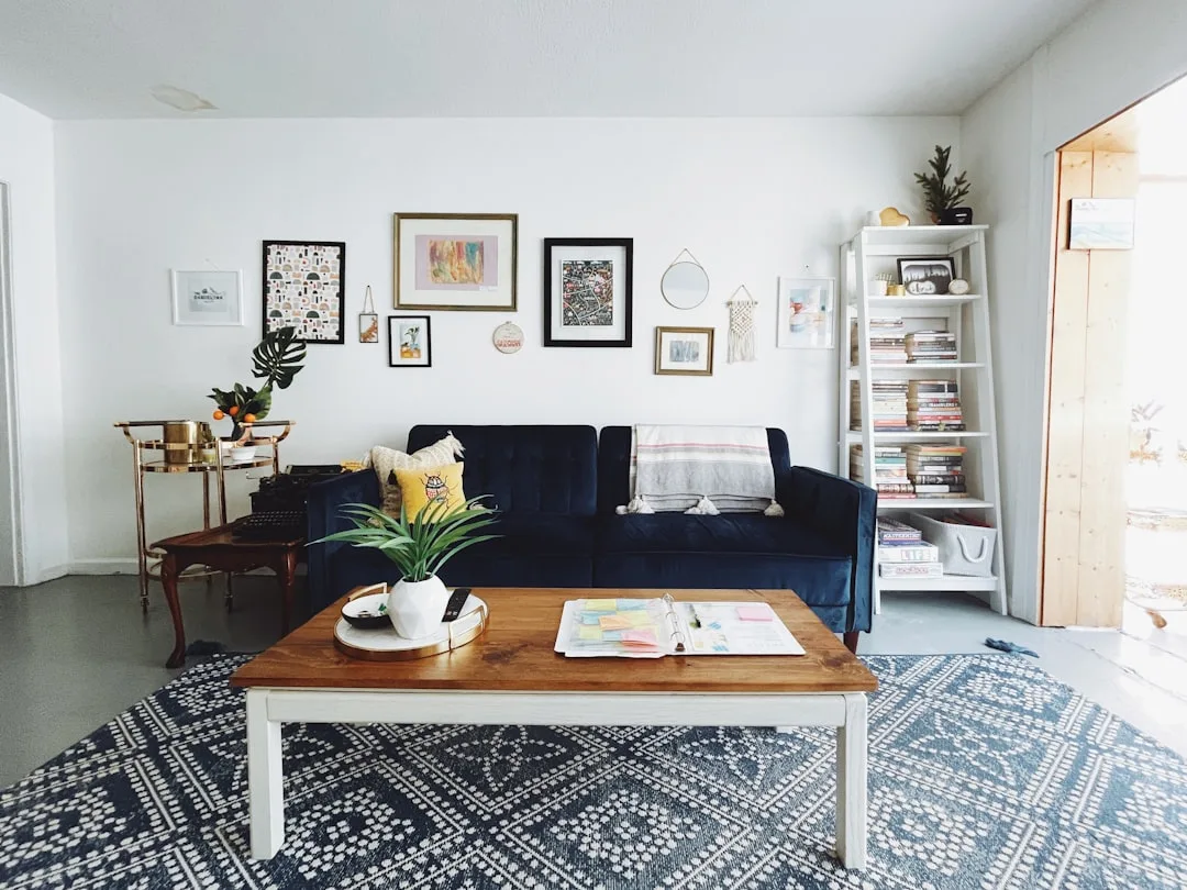 Small living room with navy blue sofa and blue patterned rug that fits properly under coffee table