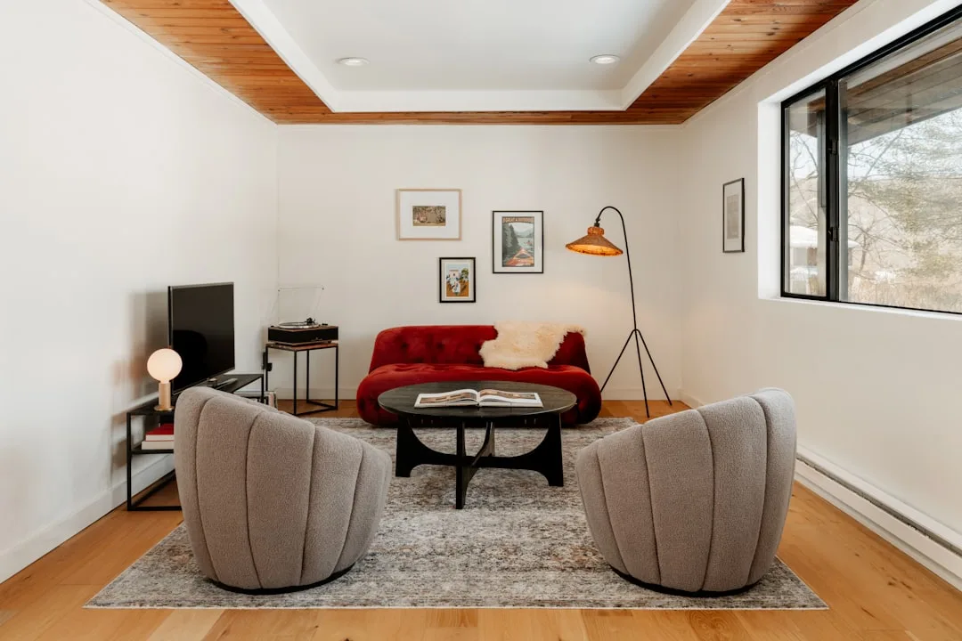 Living room with two gray chairs and no side tables, showing the common mistake of seats without nearby surfaces