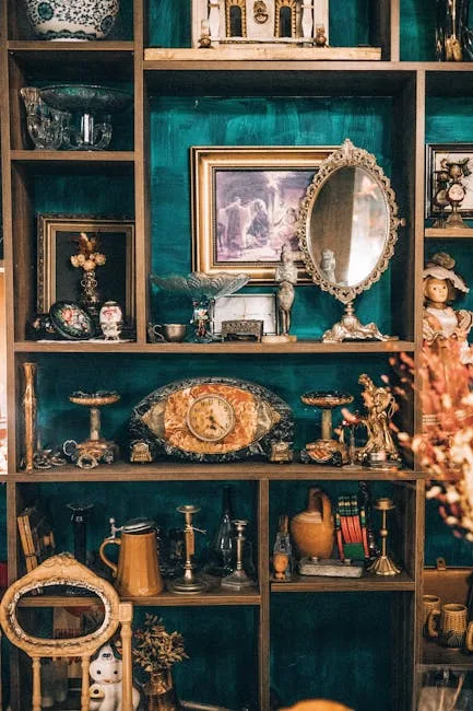 Antique thrift store shelves displaying vintage mirrors, clocks, brass candlesticks, figurines and decorative collectibl