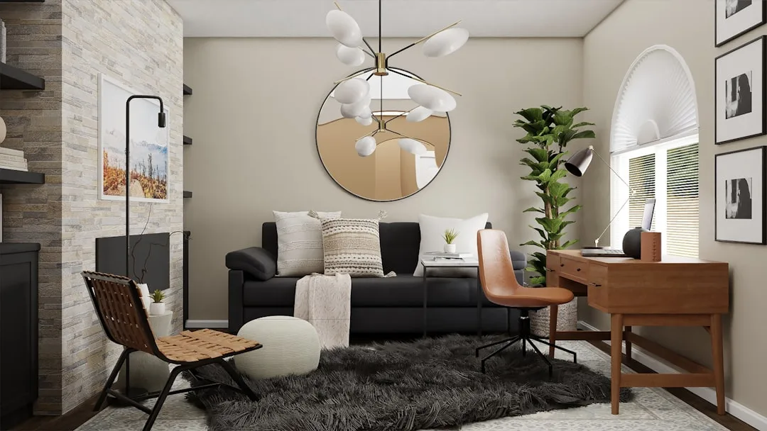Modern living room with black sofa, wood desk, chandelier, and mixed furniture for budget interior design breakdown