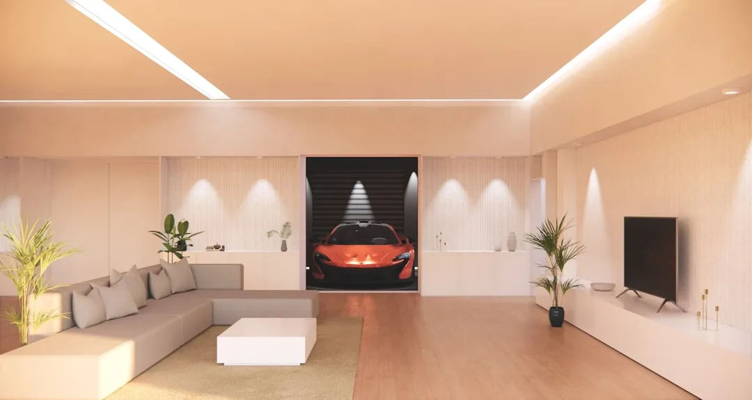 Modern living room with warm LED cove lighting, recessed spotlights, and ambient wall lights showing layered lumen desig