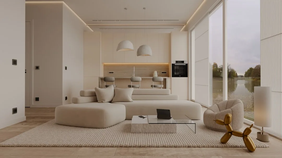 Modern minimalist open-plan living room with cream sectional sofa, glass coffee table, and floor-to-ceiling windows in c