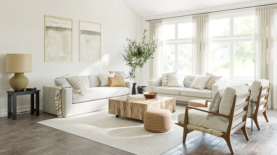 Neutral living room with two cream sofas, rustic wood coffee table, woven pouf, and armchair styled around a white area 