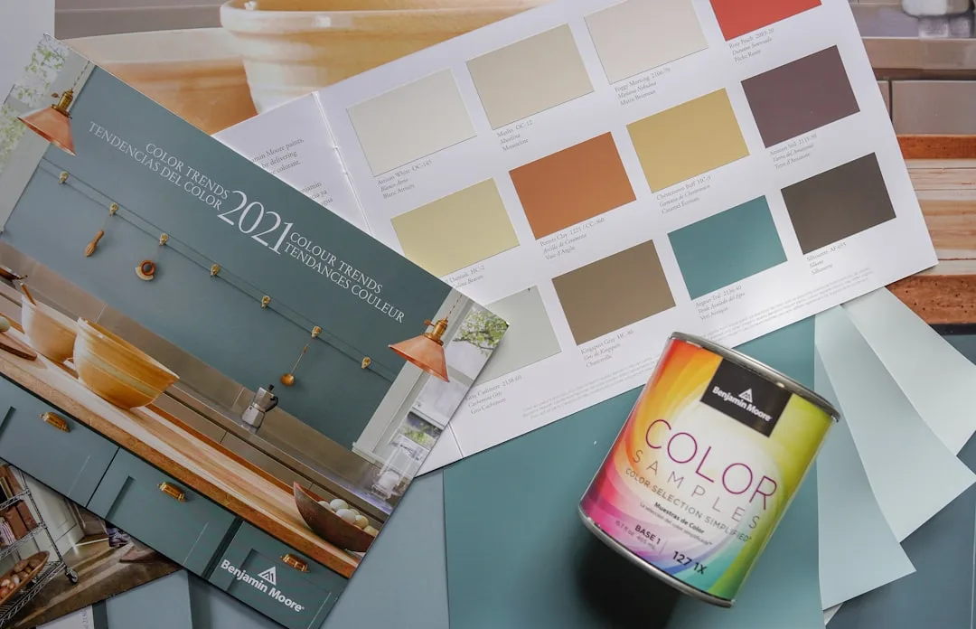 Benjamin Moore 2021 color trends brochure with paint swatches and Color Samples can on teal surface