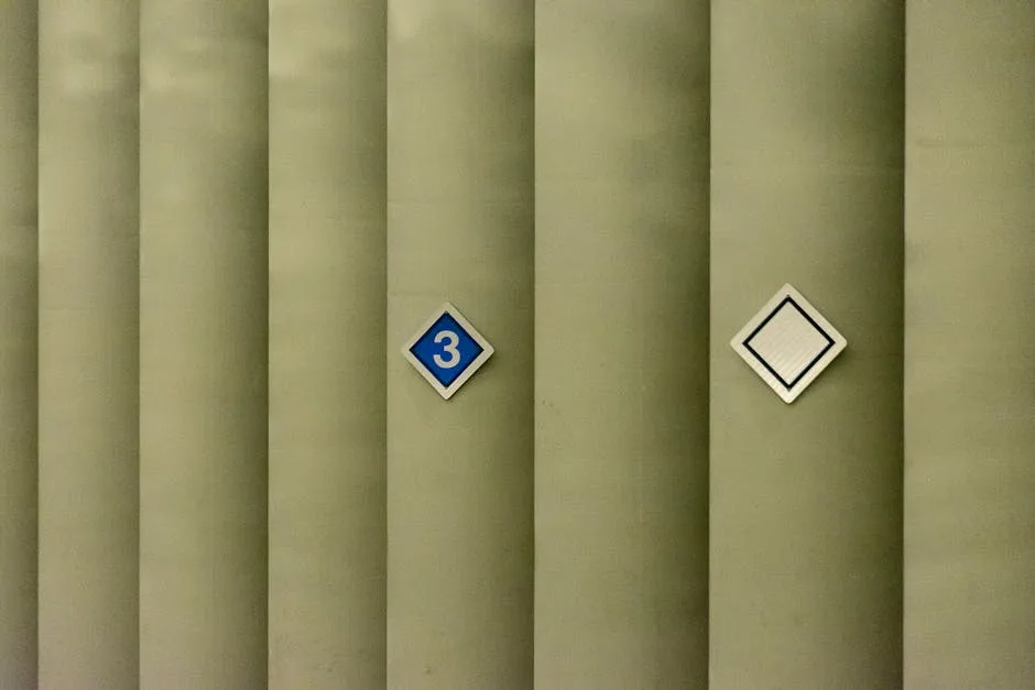 Diamond-shaped number 3 sign on industrial green columns illustrating the 3-5-7 decorating rule in minimalist spaces