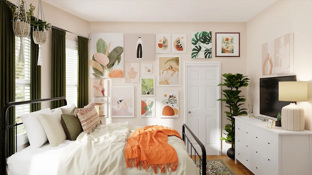 Boho dorm room aesthetic with gallery wall, green curtains, orange throw blanket and plants in small bedroom