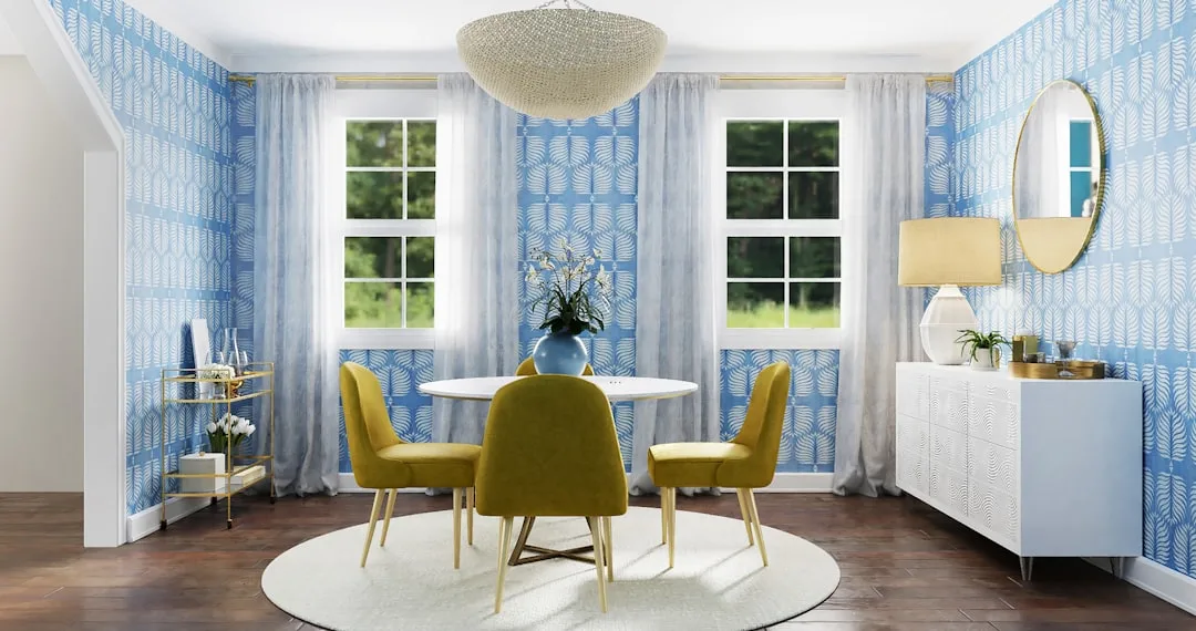 Dining room showcasing 60-30-10 color rule with blue wallpaper, white furniture, and mustard yellow chairs