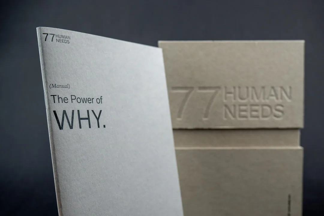 77 Human Needs manual titled The Power of Why alongside embossed cardboard box branding