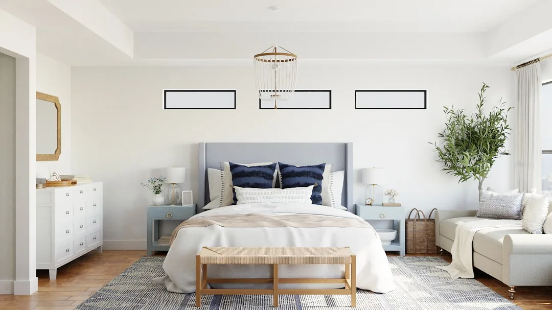 Coastal bedroom with blue headboard and white bedding demonstrating 70/30 neutral-to-accent color decorating rule