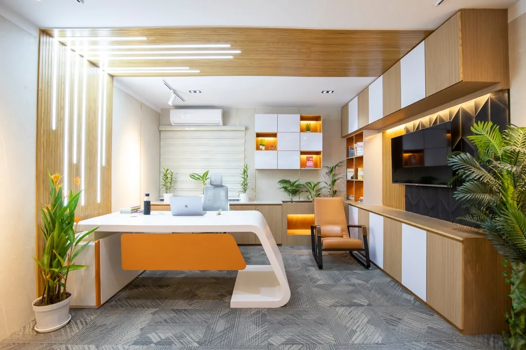 Modern executive office showcasing 70/30 design rule with white desk, wood accents, and warm orange highlights