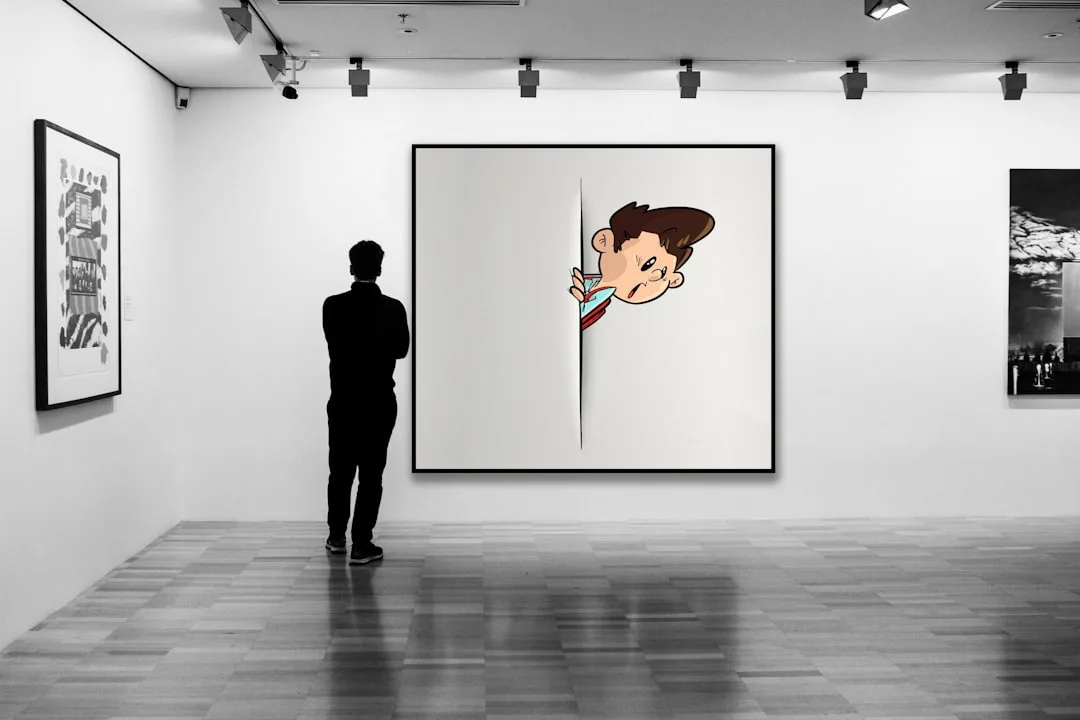 Person viewed from behind standing in art gallery examining large framed artwork hung on white wall at eye level