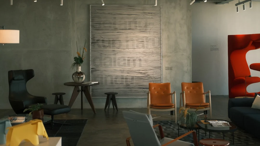 Mid-century modern furniture showroom with leather chairs, Vitra Living Tower, and textile wall art